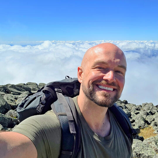 Mr Ryan Connors hiking in the mountains